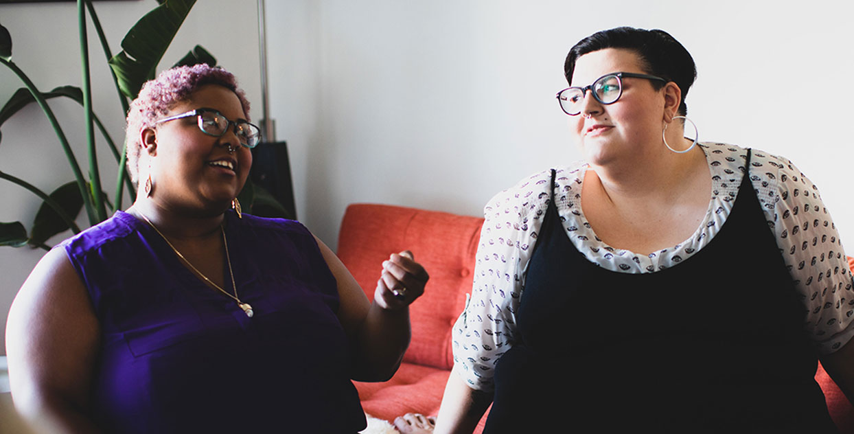 Two women talking on couch